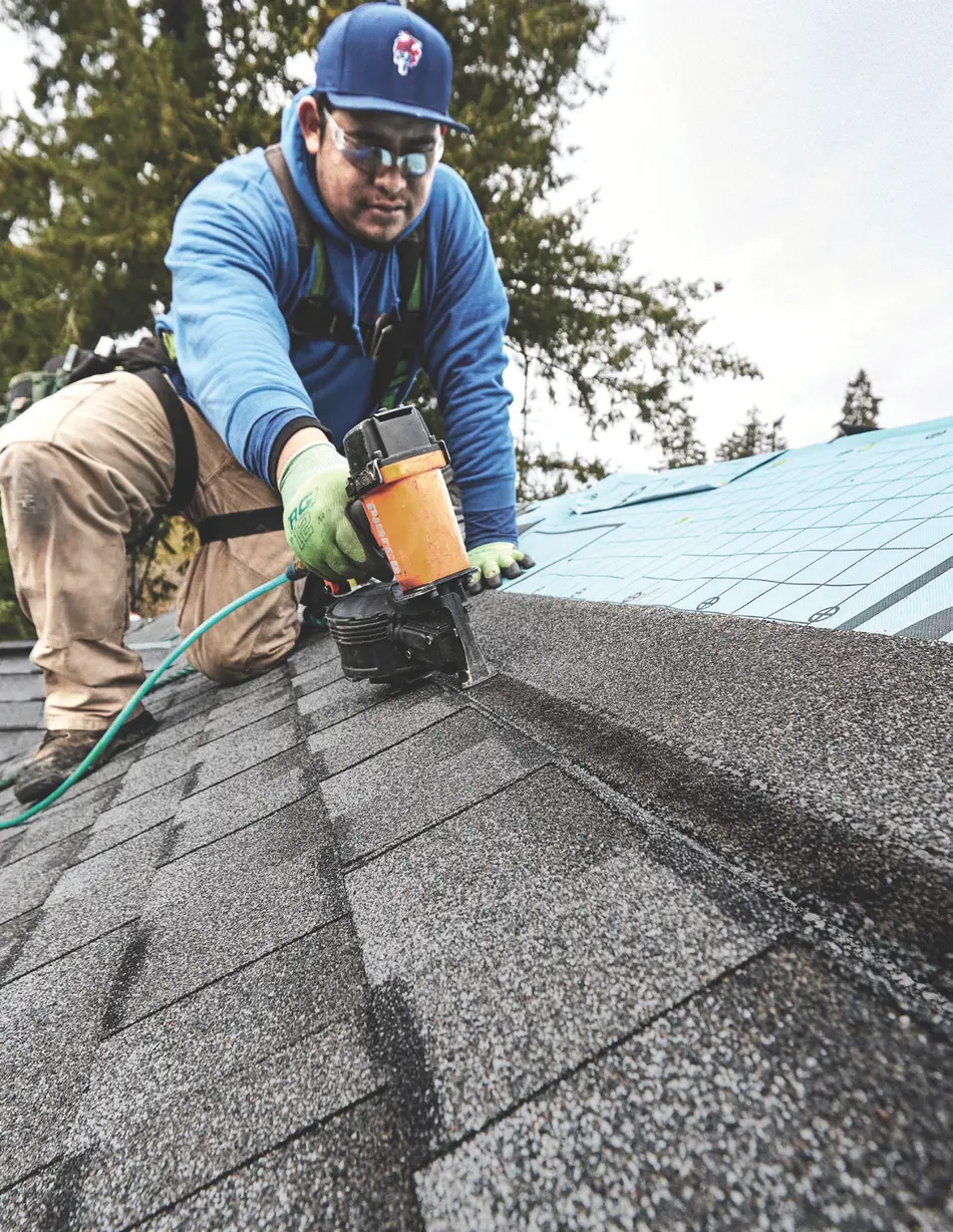 Roofer installing GAF Timberline UHDZ shingles with LayerLock technology