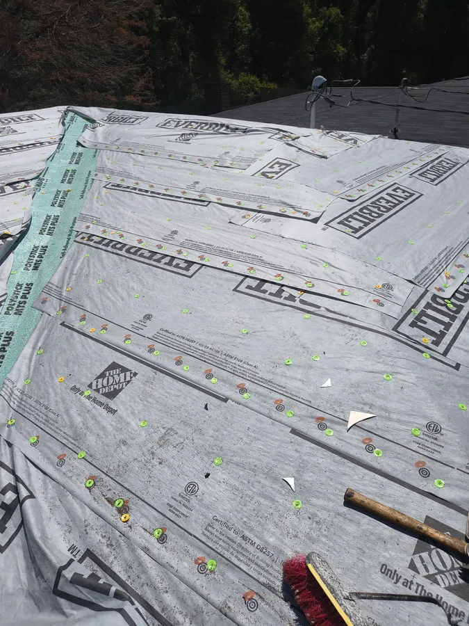 New roof decking with peel and stick underlayment installed after tree damage