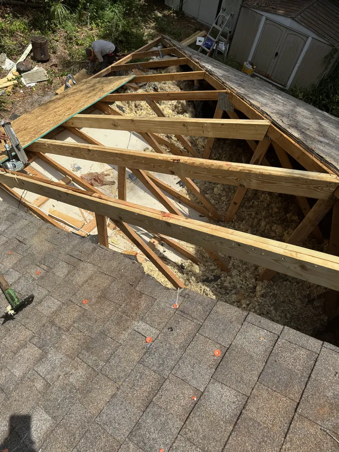 Exposed roof framing being rebuilt after tree damage, Central Florida
